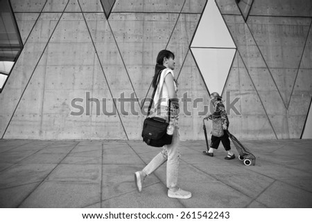 Taiwan - February 22.2015: Chinese old woman and a young woman walking in the Kaohsiung city Dadong arts center