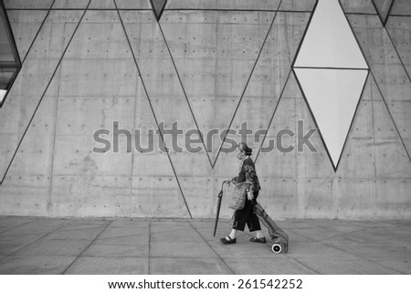 Taiwan - February 22.2015: Chinese old woman walking in the Kaohsiung city Dadong arts center