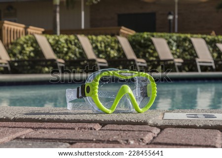 Green diving goggles by the pool, Florida