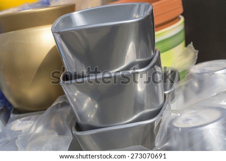 Colorful ceramic silver pots in market, collection of flowerpots