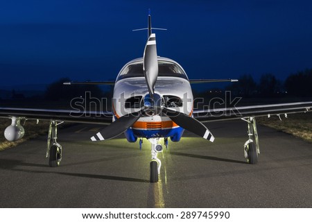 Small private single-engine piston aircraft on runway, front view