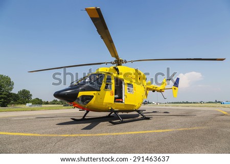 Helicopter rescue, Yellow helicopter on the ground, all logos and text removed.