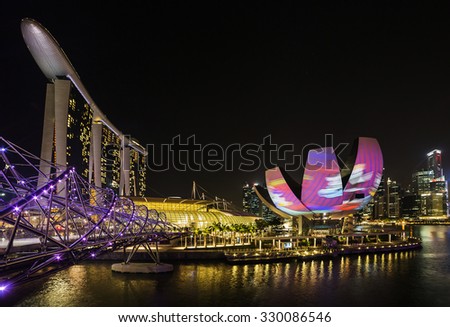 Light shows a panorama of Singapore, March 29, 2014 in Singapore. Night light show at Supertree Groveis is main Marina Bay Sands district tourist attraction
