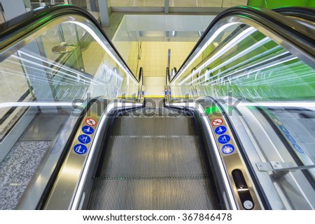 Top view of escalators, green color combination. panoramic angle of escalator detail.