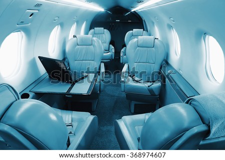 Businnes turboprop aircraft interior - seats with lowered armrests. Blue colored.