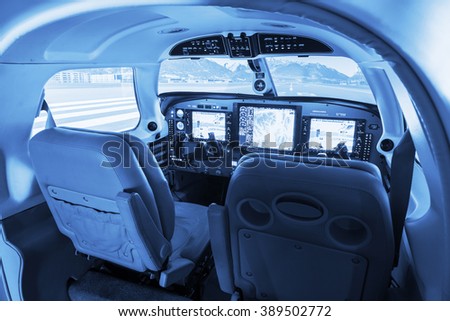 Detail view on flight simulator cockpit for small private airplanes, blue colored.