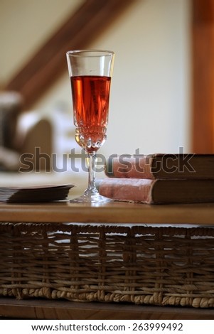 pink wine and old books on the table/ 	pink wine and old books on the table