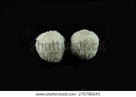 Two white asian cakes with coconut, crushed peanuts and honey