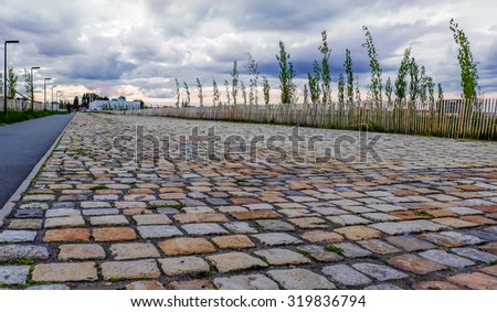 Bordeaux, France, bicycle and pedestrian alley with old cobblestones along the river Garonne