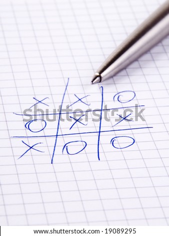 Tic Tac Toe known also as Noughts And Crosses and silver pen on notebook
