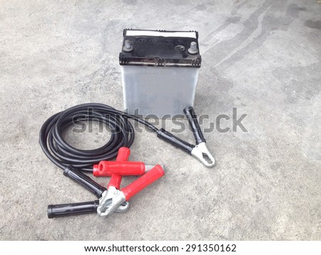 Repair of car batteries with Car battery charger at dirty parking , Bulbs, fluids and battery