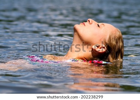 Profile of young nice girl in water
