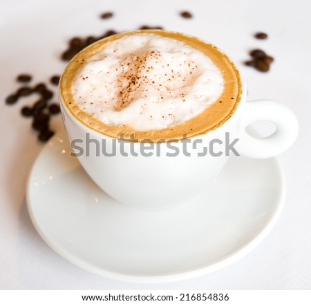 Cappuccino with whipped cream and coffee bean