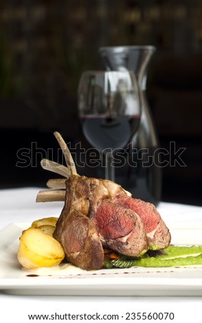 Grilled lamb steak with roasted potatoes, peas puree and wine