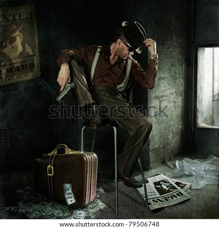 Lonely gangster with gun and suitcase full of money. Art-photo in original style