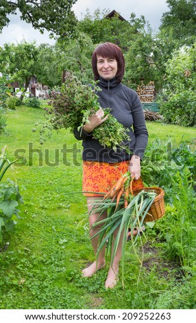 Proud gardener with her harvest. Naturally lit photograph with no arranging.