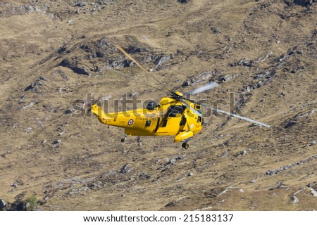 Camusrory, Scottish Highlands, UK - MAY 1: RAF Sea King helicopter XZ589 passing by Sourlies bothy on May 1, 2012 at Camusrory, Western Highlands.