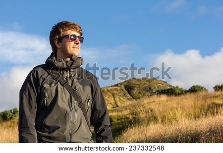 Young handsome man in waterproof jacket. Image with rich colors and copy space