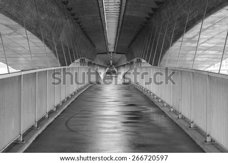 Image of man walking in the middle of highway structure. 21st century urban living concept where people are surrounded by concrete