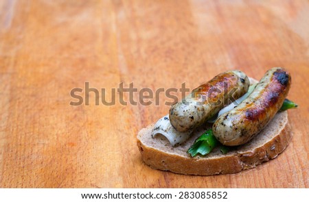 Food right out of BBQ. German sausages with spring onions and rye bread. Copy space for your text on right side of the image
