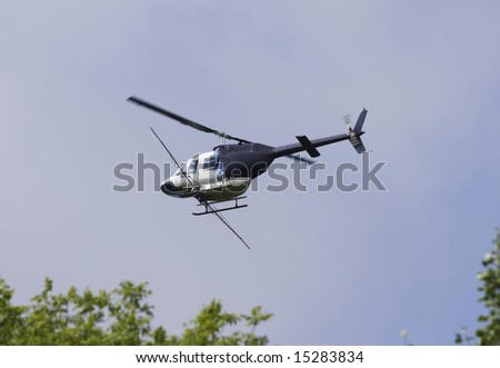Crop sprayer duster helicopter, spraying mountains, fields and land