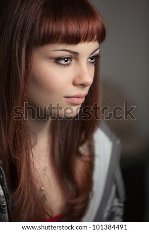 A beautiful and sensual young red haired girl posing. Shallow depth of field on model\'s eyes