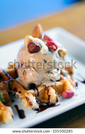 a selection of three italian gelato ice-cream scoops topped with nuts, chocolate, fruit served on crispy waffels