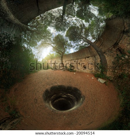 A mysterious well on the floor of a ruin lost in the woods