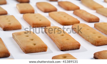 A set of pastry cookies just baked and put in line. Shallow depth of field with focus on the foreground line