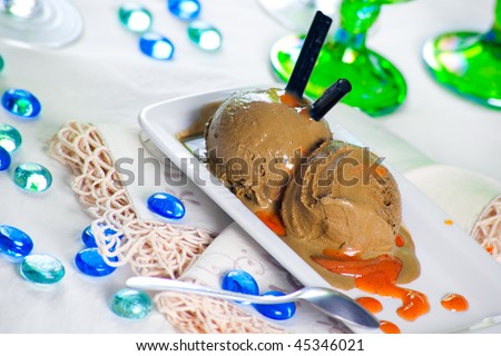 A plate of Liquorice Ice Cream with cajeta mexican caramel sauce as topping. Shallow depth of field on the ice cream balls