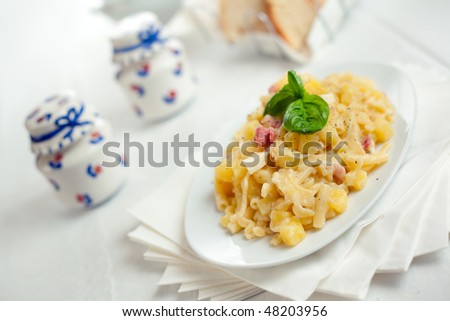 Pasta with Potatoes Provola Cheese and Bacon on a white table