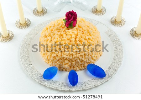 Mimosa cake made of sponge cake, cream patisserie, whipped cream and orange flavored. Decorated with small cubes of spongecake all over