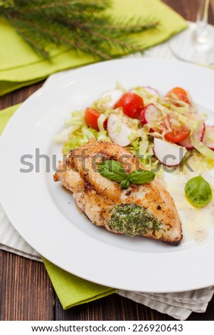 chicken breast with green sauce, vegetables and couscous