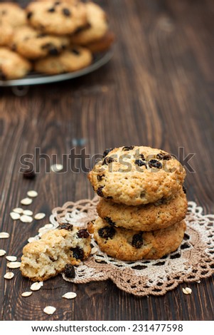 Cookies from oatmeal and raisins on a dark wooden background