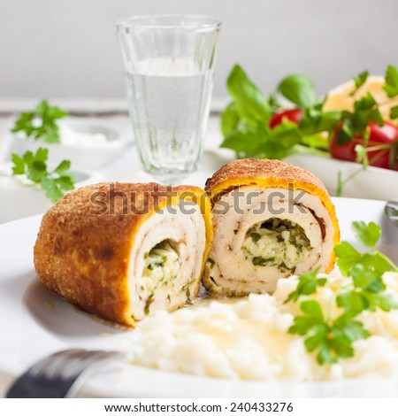 chicken Kiev with mashed potatoes.Ã?Â  Chop chicken fillet stuffed with juicy butter, cheese and greens on a white plate