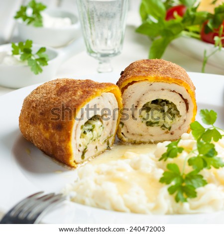 chicken and chicken Kiev with mashed potatoes.  Chop chicken fillet stuffed with juicy butter, cheese and greens on a white plate