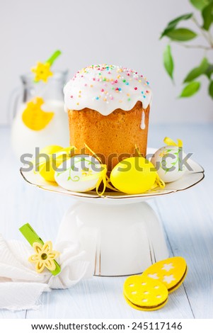 Easter cakes and colored eggs on a light wooden background