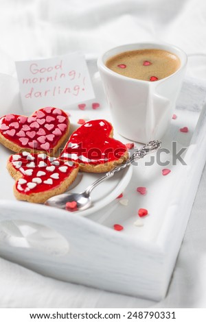 white tray with a cup of coffee and biscuits in bed for the beloved