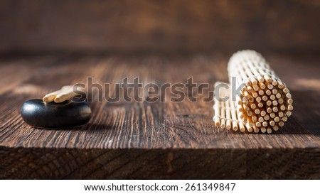 mat for sushi and chopsticks on dark wooden background. Copy space