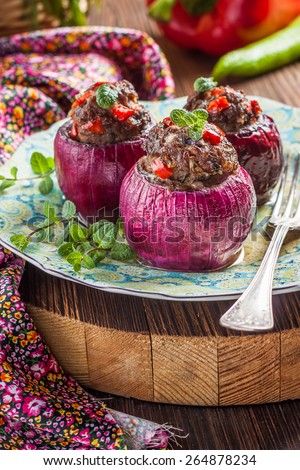 Red onion stuffed lamb with mint and paprika on a dark wooden background