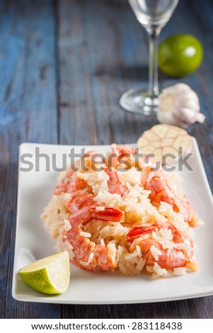 shrimp with garlic, lime and rice. Asian cuisine. Spicy sweet and sour shrimp, fried rice, garlic and lime