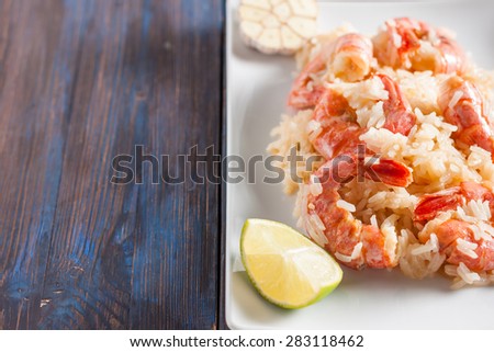 shrimp with garlic, lime and rice. Asian cuisine. Spicy sweet and sour shrimp, fried rice, garlic and lime
