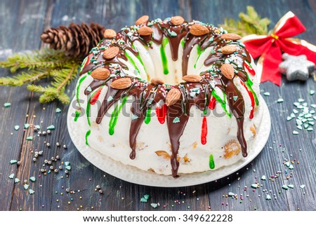 Christmas ice-cream cake.\
Filling - eclairs with sea buckthorn cream with whipped cream. Cake is decorated with chocolate ganache, almonds and colored glaze