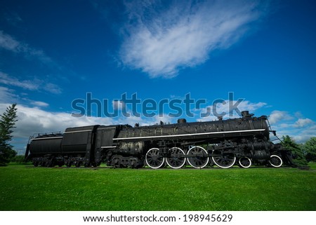 A large, black, iron antique steam train - known as a 484, or 'Northern' model of classic steam engine locomotive, commonly used in service in the early half of the 20th century.