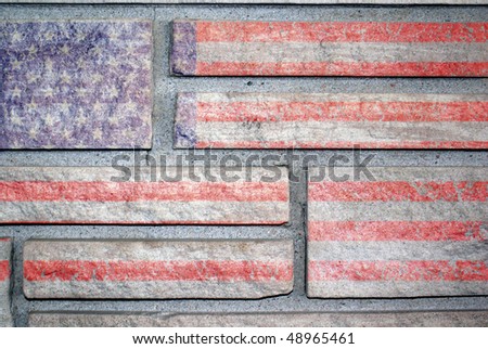An American flag painted on the surface of a stone wall.