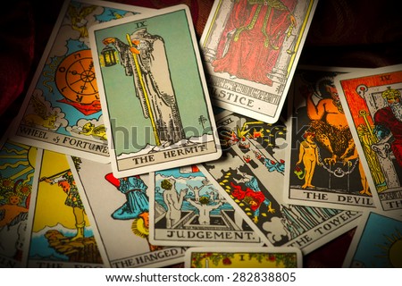 A pile of tarot trump cards jumbled, scattered and haphazardly arranged.