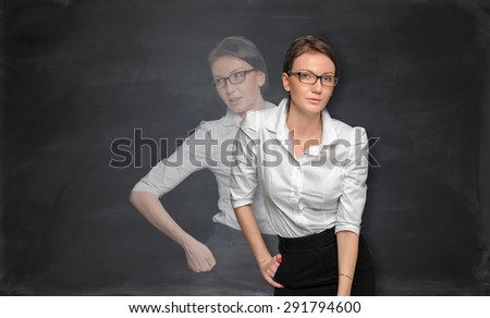 Young pretty woman in office suit standing near the blackboard. Double exposure