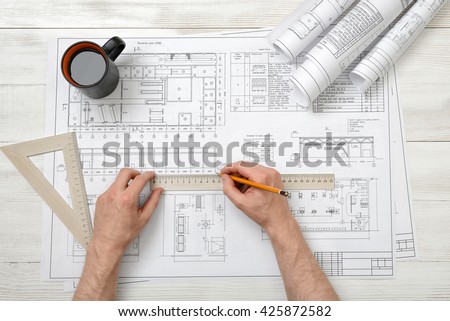 Man hands draw design with pen and wooden rulers. Working process. Technical drawing. Workplace of architect or constructor. Engineering work. Construction and architecture.