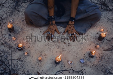 woman with candle deep in forest. Witch craft concept
