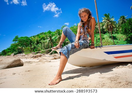 smilling young woman sitting on the boat